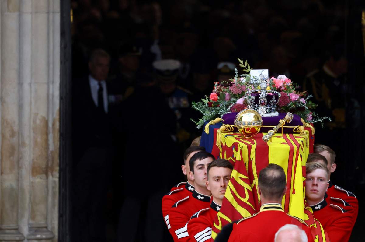 The coffin of Britain’s Queen Elizabeth is carried out of the Westminster Abbey on the day of her state funeral and burial, in London, Monday Sept. 19, 2022. (Hannah Mckay/Pool Photo via AP)