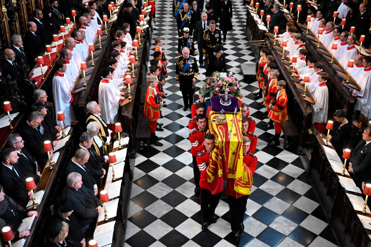 Britain’s King Charles III, left, Camilla, Queen Consort, Princess Anne, Vice Admiral Timothy Laurence, Prince Andrew, Prince Edward, Sophie, Countess of Wessex, Prince William, Prince George Catherine, Princess of Wales, Prince Harry and Meghan, Duchess of Sussex walk behind the coffin of Queen Elizabeth II as they leave Westminster Abbey in central London, Monday Sept. 19, 2022.  (Ben Stansall/Pool via AP)
