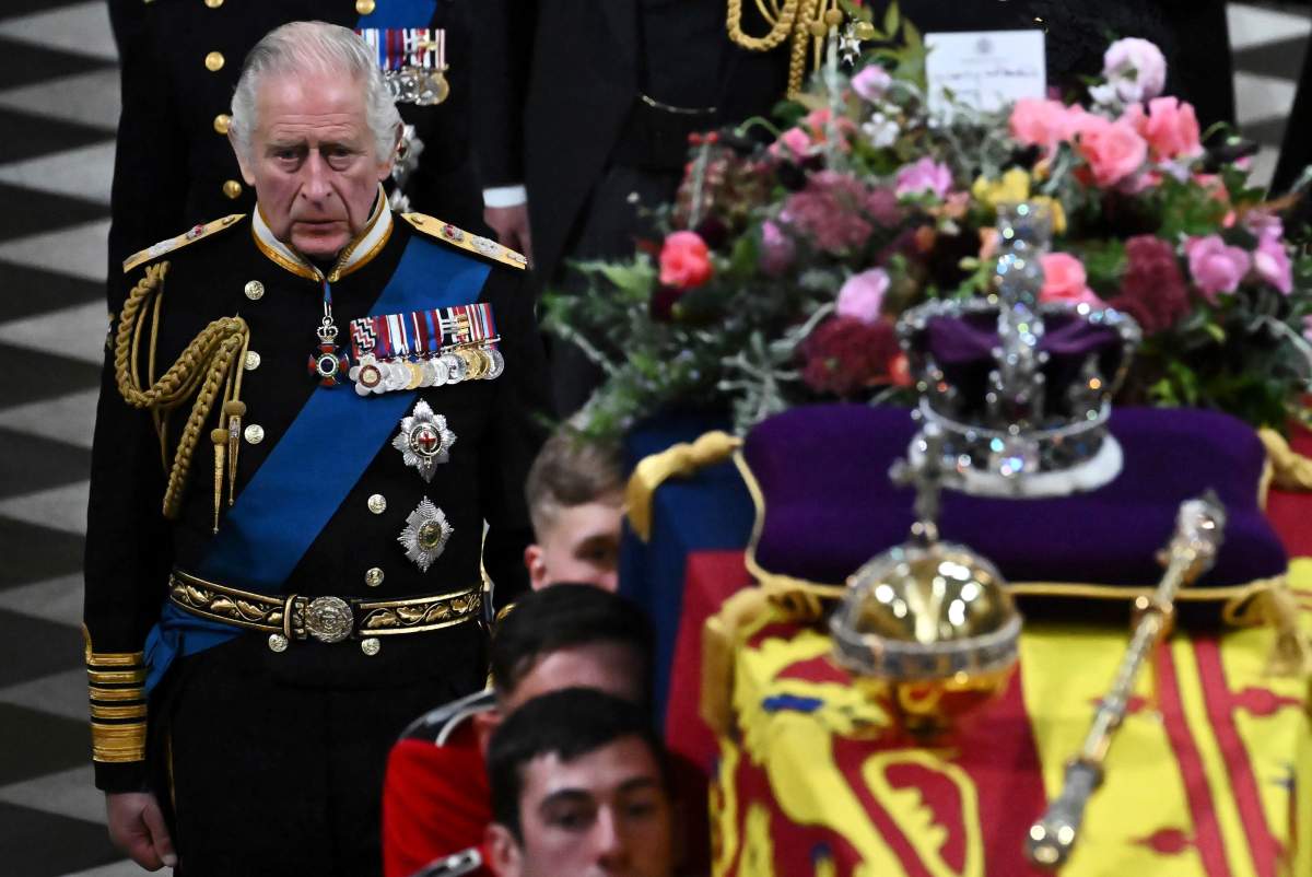 Britain’s King Charles III walks behind the coffin of Queen Elizabeth II in Westminster Abbey in central London, Monday Sept. 19, 2022.  (Ben Stansall/Pool via AP)