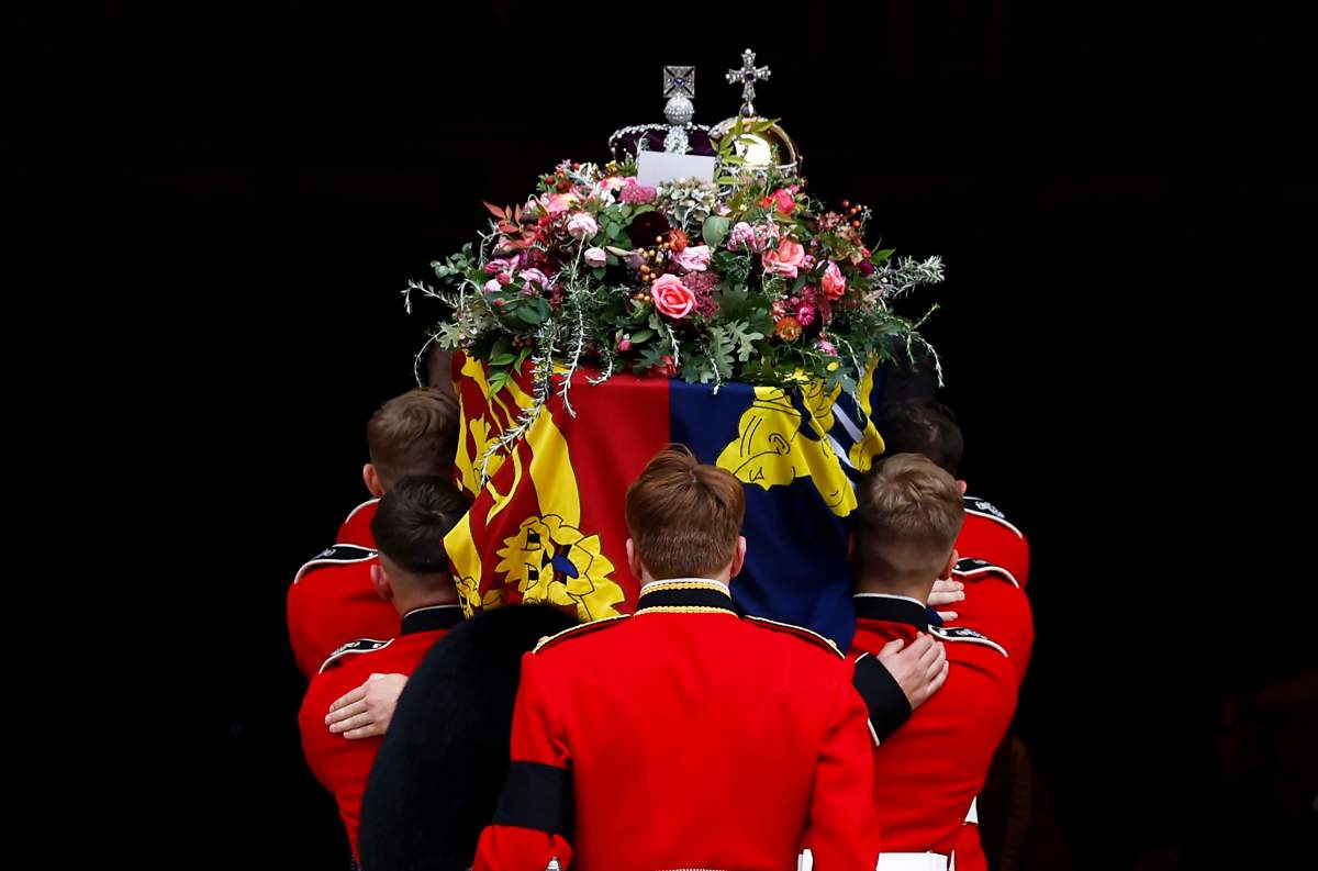 Pall bearers carry the coffin of Queen Elizabeth II with the Imperial State Crown resting on top into St. George’s Chapel, in Windsor, England, Monday Sept. 19, 2022, for the committal service for Queen Elizabeth II. (Jeff J Mitchell/Pool Photo via AP)