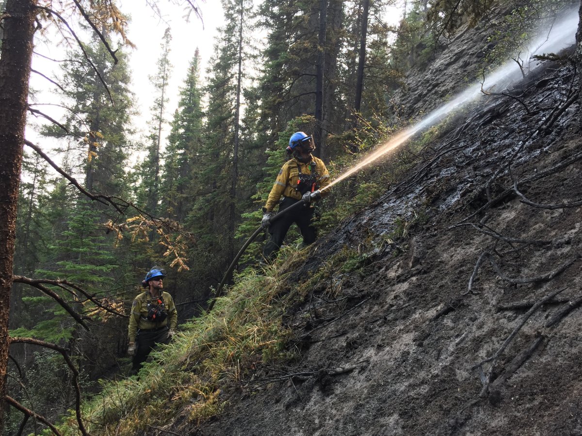 Firefighters work on the Chetamon wildfire in Jasper National Park Sept. 18, 2022.