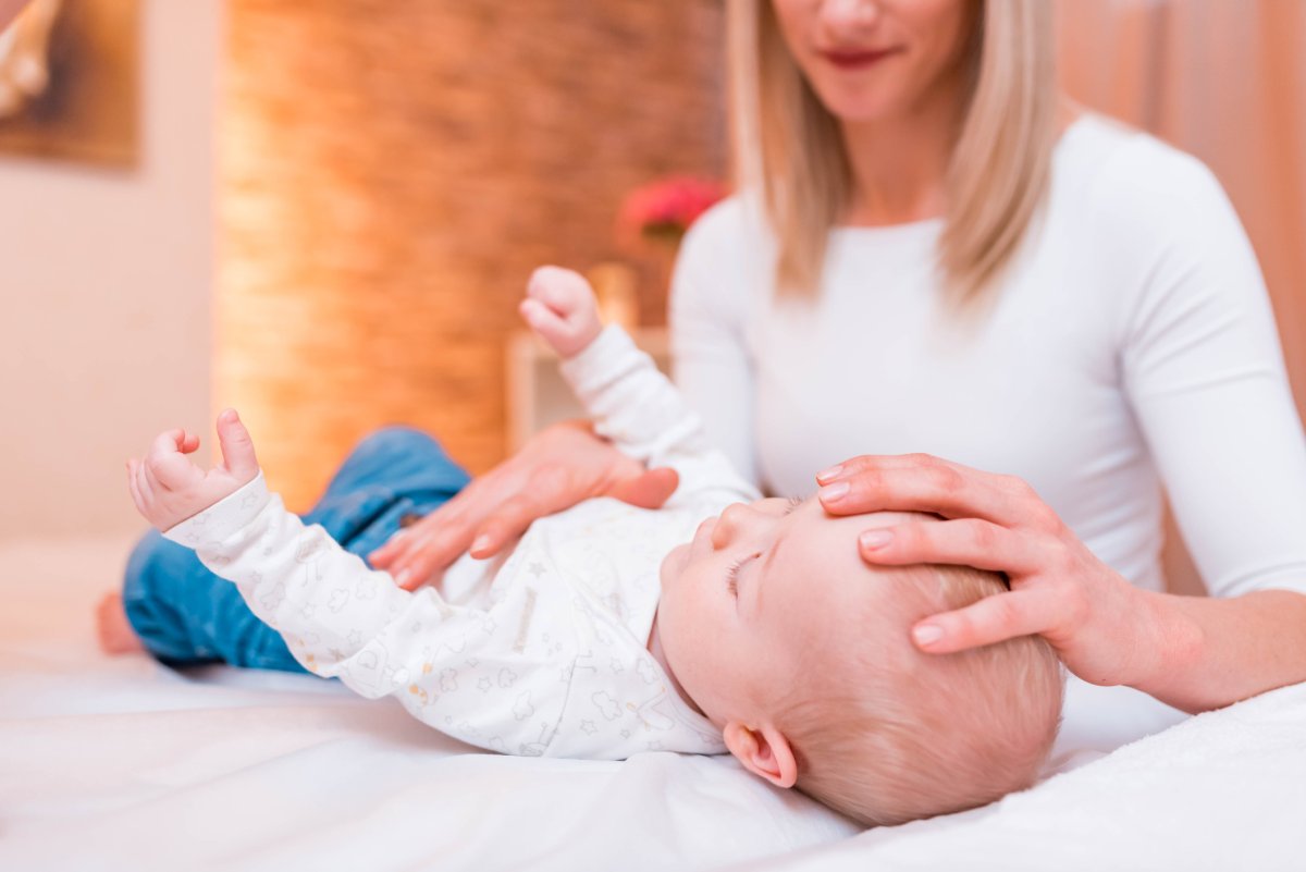 A photo illustration of a baby receiving chiropractic care.