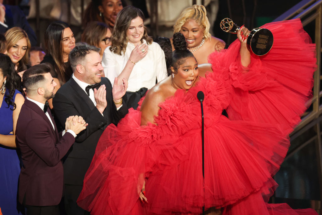 US singer-songwriter Lizzo (R) accepts the award for Outstanding Competition Program for "Lizzo's Watch Out For the Big Grrrls" onstage during the 74th Emmy Awards at the Microsoft Theater in Los Angeles, California, on September 12, 2022.