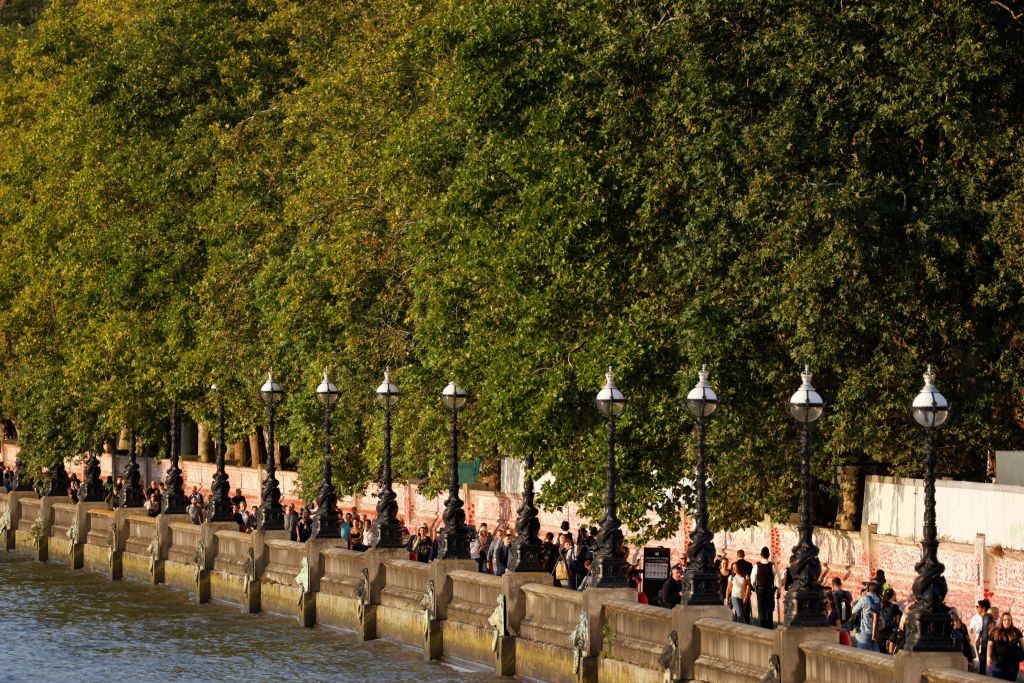 Members of the public queue along the South Bank of the River Thames as they wait in line to pay their respects to the late Queen Elizabeth II, Lying-in-State in the Palace of Westminster in London on September 14, 2022.