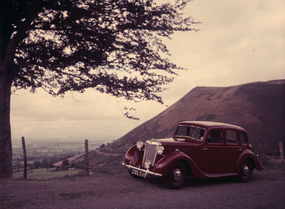 A maroon Triumph car is shown in 1952.