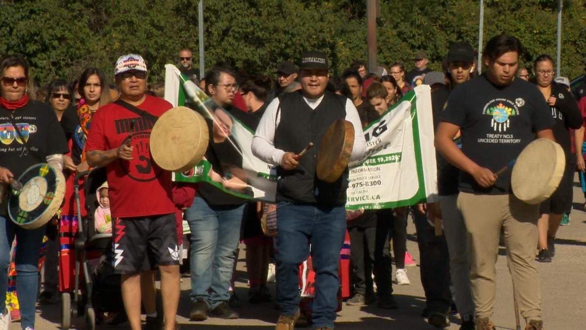 Residents from Saskatchewan can be seen walking through the streets of Saskatoon on Sept. 18, 2022 as they raise awareness for Megan  Gallagher who went missing two years ago. 