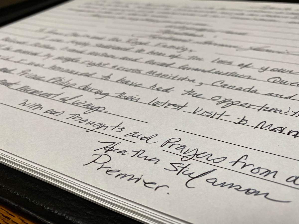 Lieutenant-governor and premier sign book of condolences marking the death of the queen.