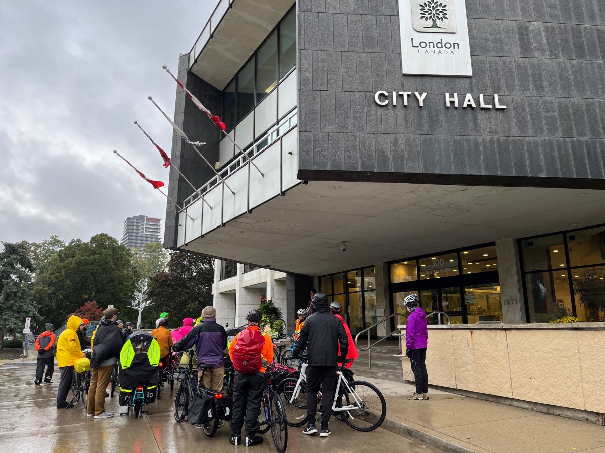 Cycling advocates gather on the front steps of London, Ont., city hall to call for improved cycling infrastructure during Tuesday's demonstration.