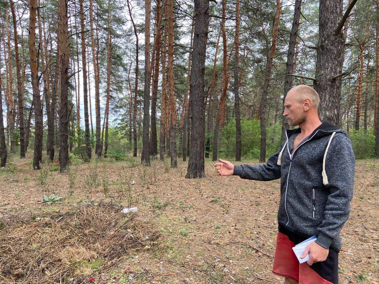 Oleksii Sukhorebryi shows the site where his nephew was found executed by Russian soldiers in Dibrova, Ukraine.