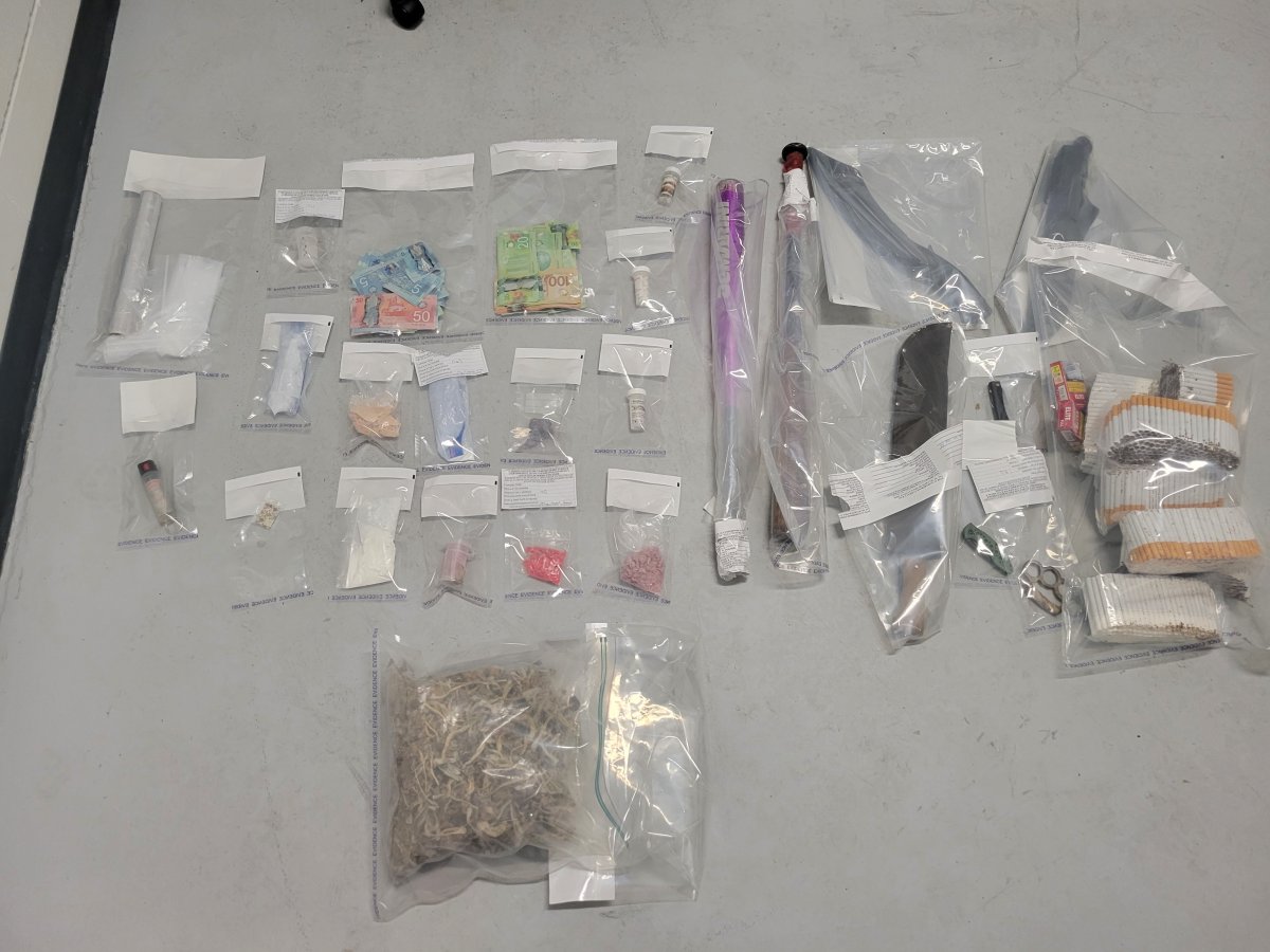 A photo of the alleged seized drugs, weapons and cash found inside a vehicle in Penticton, B.C., on Wednesday.