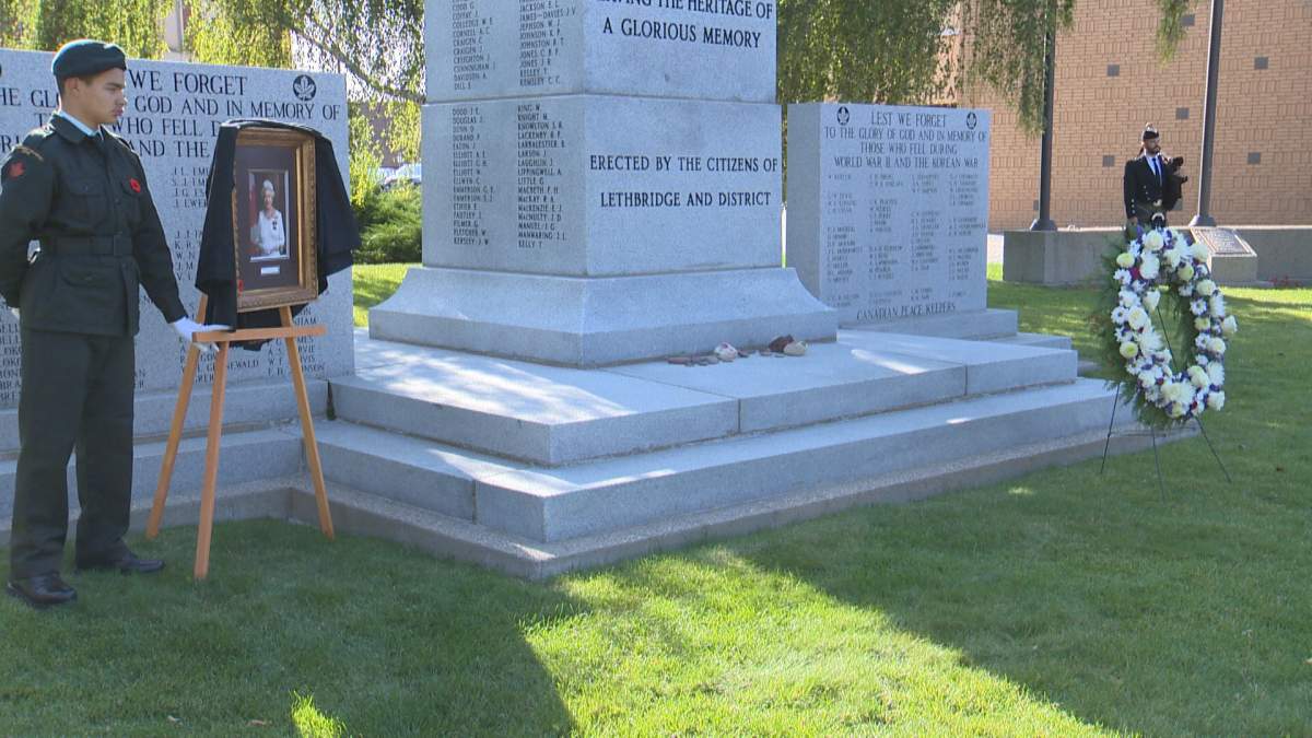 A picture of Queen Elizabeth II stands by the Lethbridge cenotaph, as a memorial service for the monarch on Sept. 19, 2022