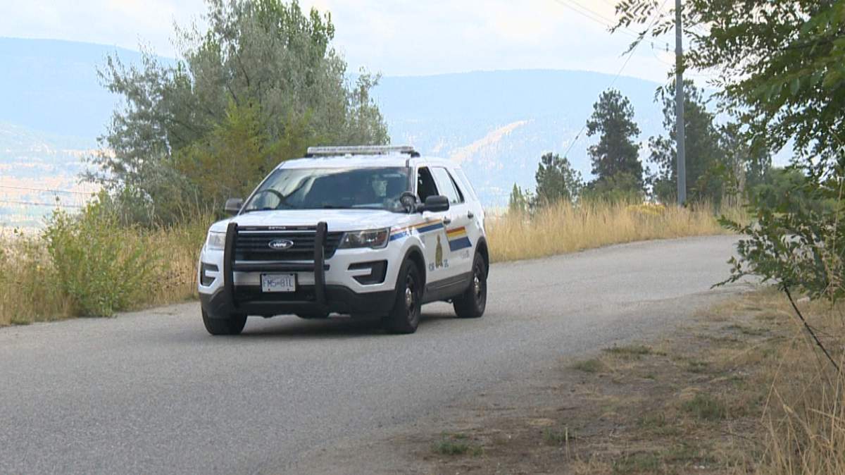 An RCMP vehicle blocks the road to the crime scene south of Summerland on Friday.