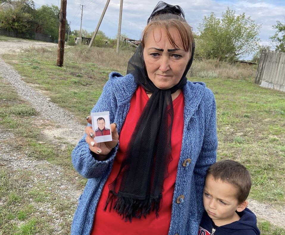 Viktoriia Nikolienko holds photo of her husband Arsen, killed by Russian forces in Dibrova, Ukraine.