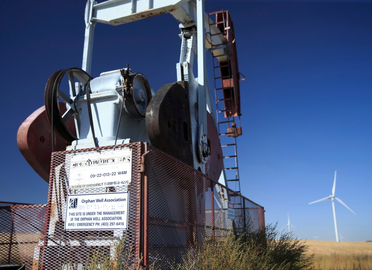 A sign, from Alberta's Orphan Well Association (OWA), identifies a non-producing and abandoned oil well, still with a pumpjack in place, near Carmangay, Alberta on Sept. 10. 2020. 