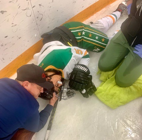 Saiva on the ice with his trainer.