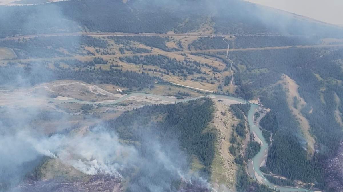 An air tanker drops fire retardant on the Chetamon wildfire in Jasper National Park Sept. 7, 2022.