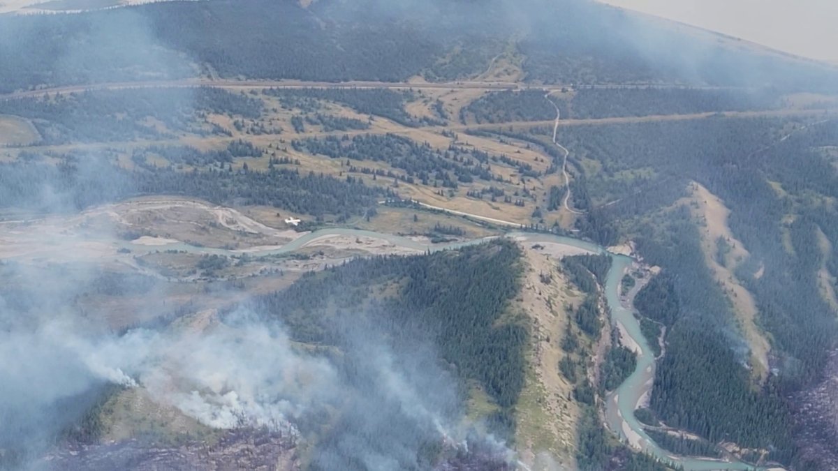 An air tanker drops fire retardant on the Chetamon wildfire in Jasper National Park Sept. 7, 2022.