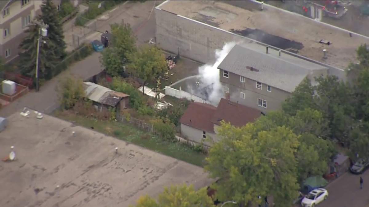 Fire crews battle a blaze at a home in the area of 96 Street and 105A Avenue Monday, Sept. 26, 2022.