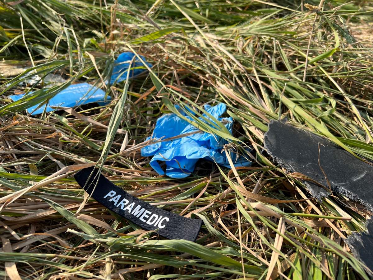 A paramedic’s badge lies in the grass on the side of Hwy. 39 after a fatal collision Sept. 10, 2022.