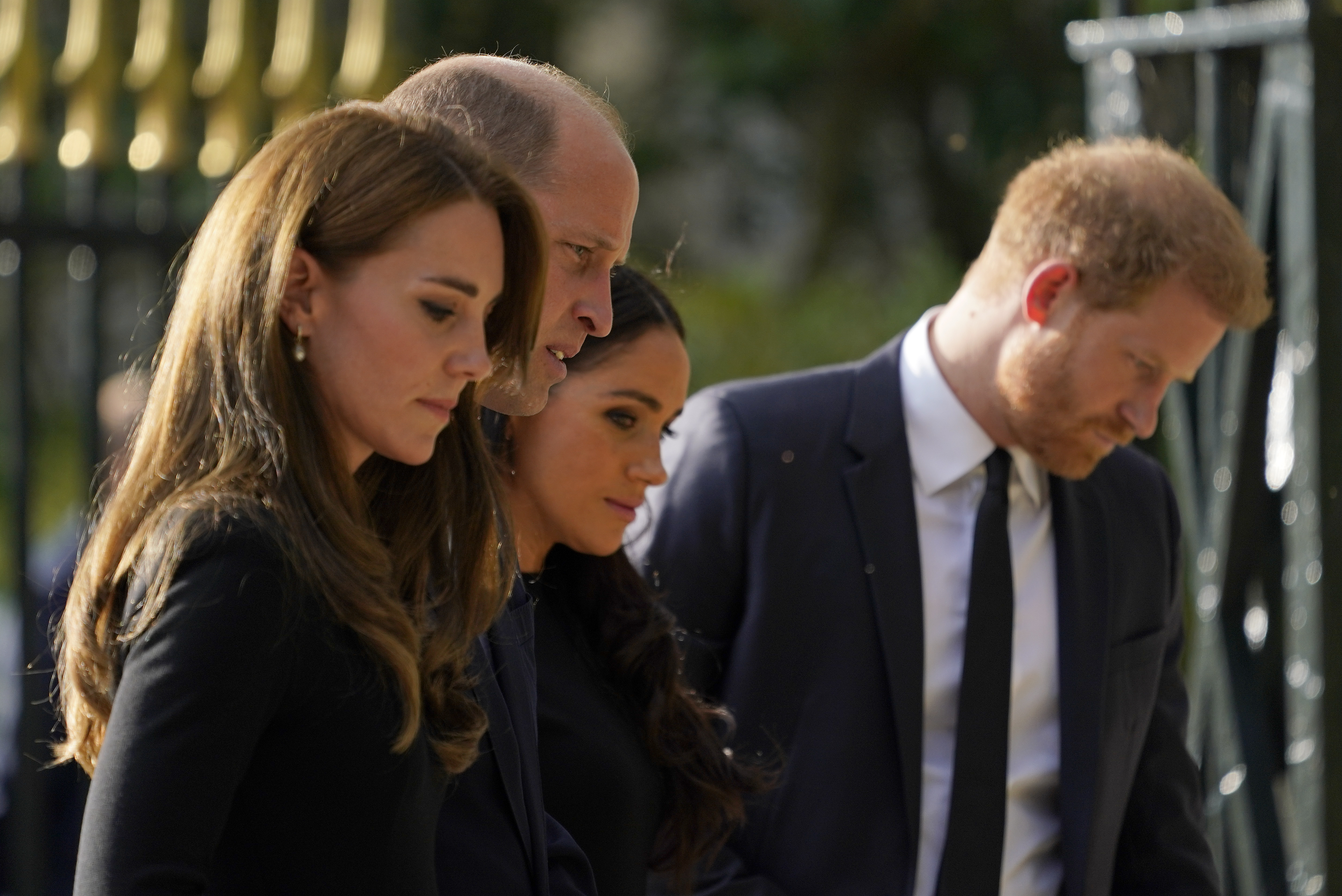 Britain's Prince William and Kate Middleton, Princess of Wales, left, and Britain's Prince Harry and Meghan Markle, Duchess of Sussex, walk to greet the crowds after viewing the floral tributes for the late Queen Elizabeth II outside Windsor Castle, in Windsor, England, Saturday, Sept. 10, 2022.