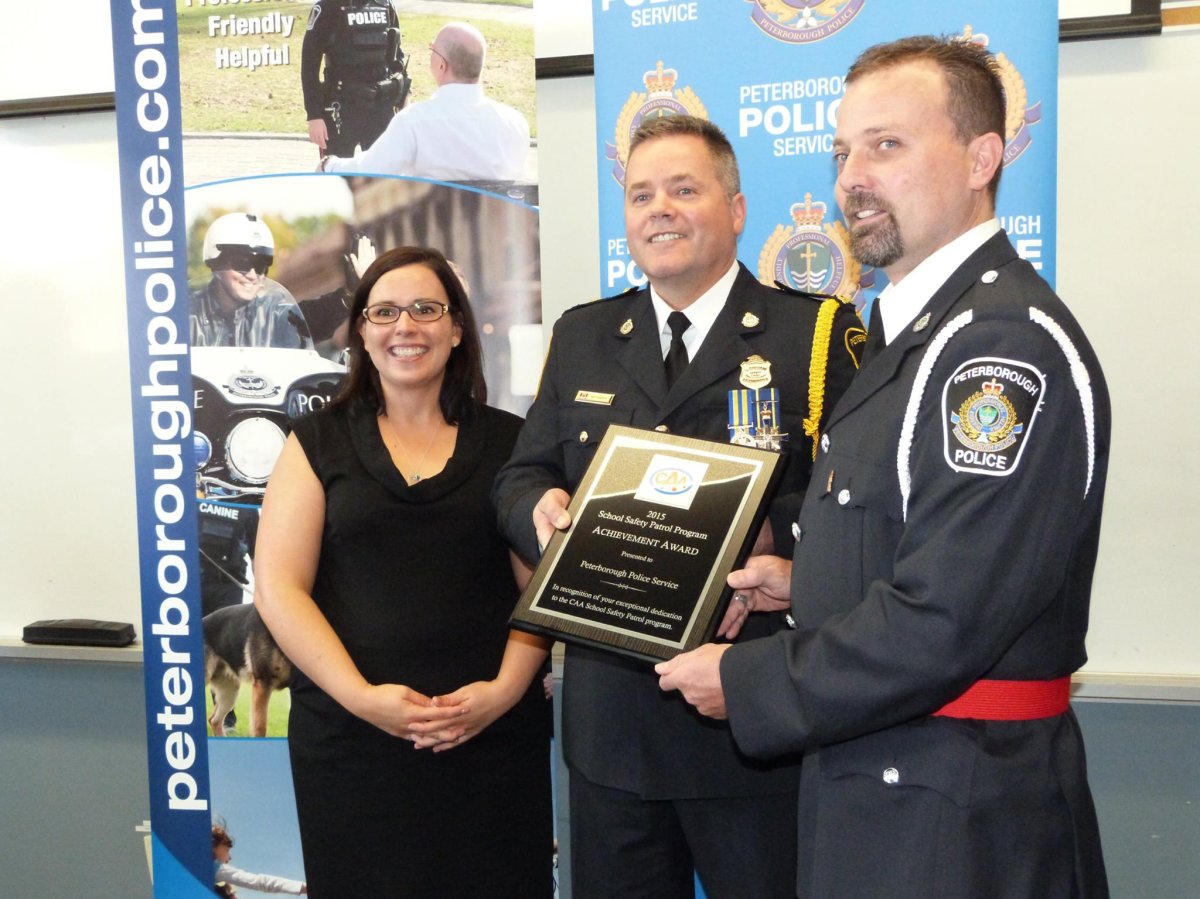 Const. John MacLeod, right, seen here in 2015 receiving the CAA School Safety Patrol Program Achievement Award.