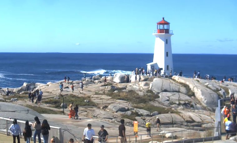 Dozens flock to Peggy's Cove Saturday morning to take in the waves from Hurricane Earl.