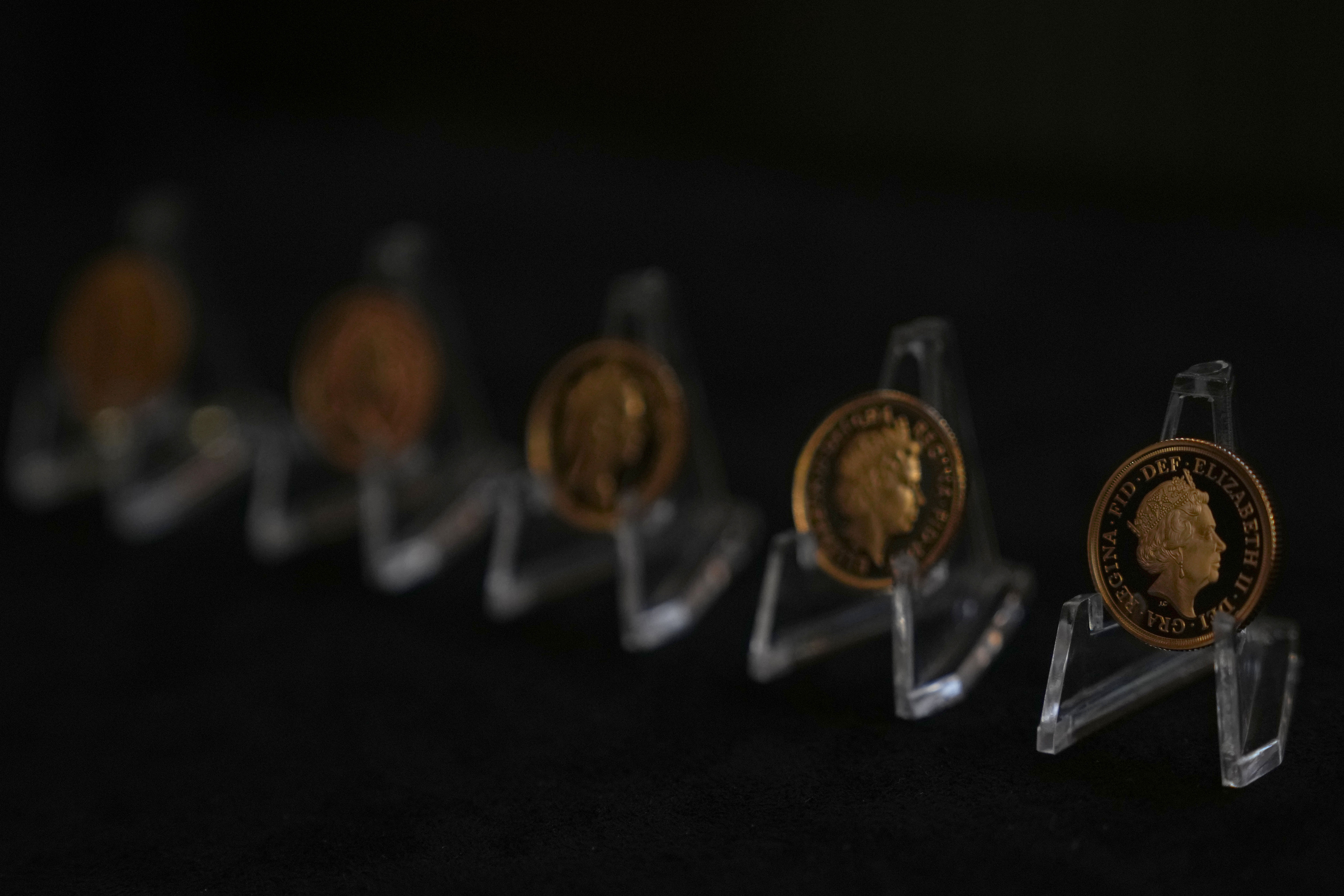 Five gold sovereigns bearing the official portraits of the late Queen Elizabeth II, on display by the Royal Mint in London, Thursday, Sept. 29, 2022. The official portrait of the monarch is updated during their reign.