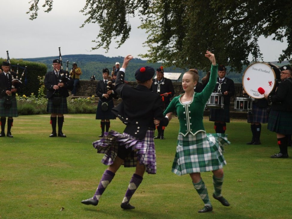 Image featuring pipers and dancers that accompanied 'Sons of Scotland' to Scotland.