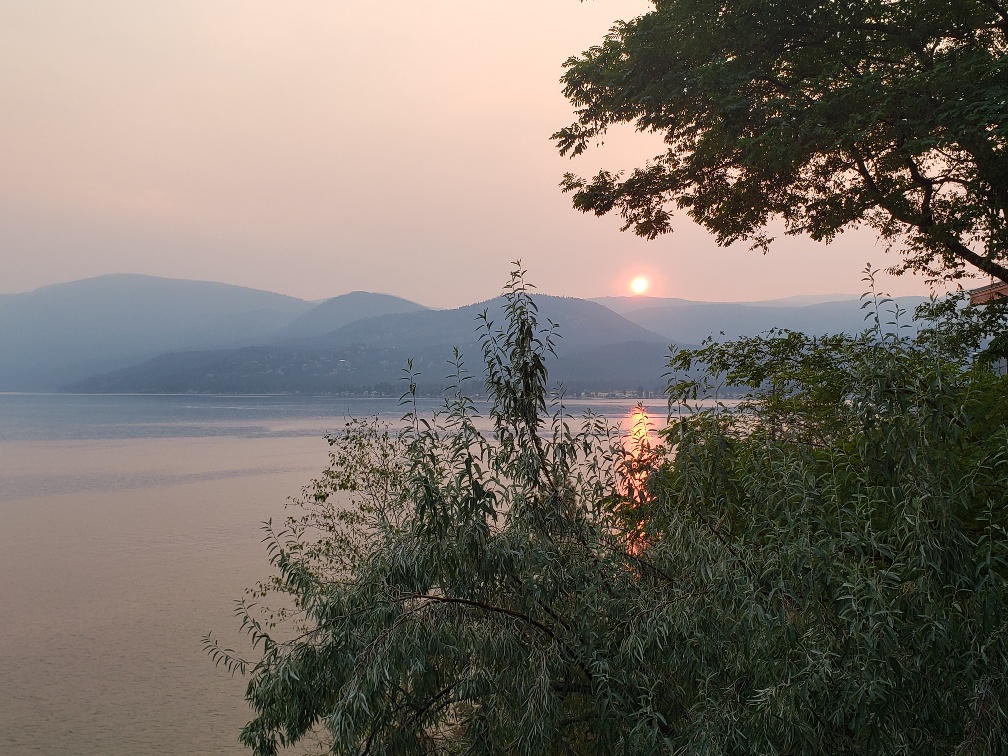 A red sunset and some smoke in the mountains in Vernon, BC.