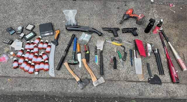 Vancouver police said officers arrested four people after discovering a weapon cache in a tent near East Hastings Street.