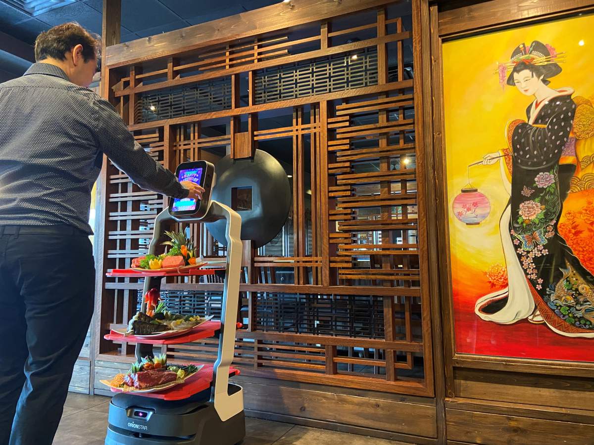 Eric Sit shows off OMOBOT.