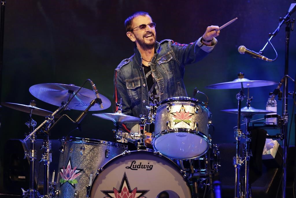 FILE - Ringo Starr plays as part of a concert celebrating the 50th anniversary of Woodstock in Bethel, N.Y., Friday, Aug. 16, 2019.