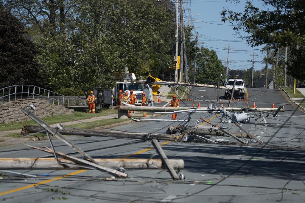 Workers assess downed power poles caused by post-tropical storm Fiona in Dartmouth, N.S., on Sunday, Sept. 25, 2022. Prime Minister Justin Trudeau has announced the creation of a $300-million fund to help with Atlantic Canada's recovery from post-tropical storm Fiona. 