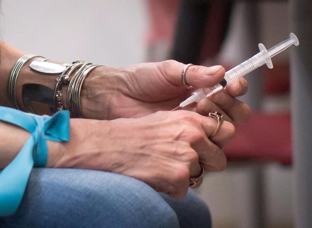 A person injects hydromorphone at the Providence Health Care Crosstown Clinic in the Downtown Eastside of Vancouver, B.C. 