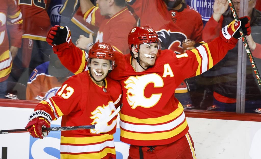 Calgary Flames forward Matthew Tkachuk, right, celebrates his goal with teammate forward Johnny Gaudreau during third period NHL second round playoff hockey action in Calgary, Alta., Wednesday, May 18, 2022.