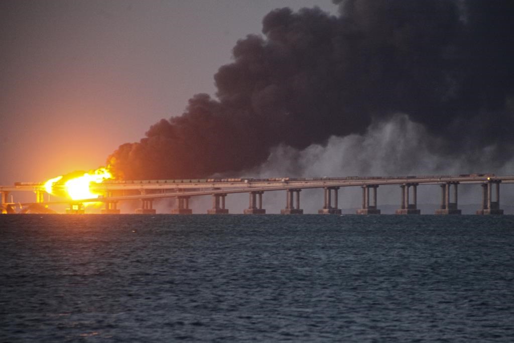 Flame and smoke rise from the Crimean Bridge connecting the Russian mainland and the Crimean peninsula over the Kerch Strait, in Kerch, Crimea, Saturday, Oct. 8, 2022. Russian authorities say a truck bomb has caused a fire and the partial collapse of a bridge linking Russia-annexed Crimea with Russia. Three people have been killed. The bridge is a key supply artery for Moscow’s faltering war effort in southern Ukraine. (AP Photo)