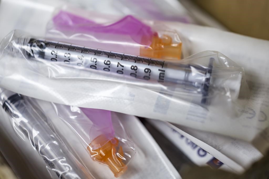 Needles and syringes used to administer flu shots are shown in a file photo.