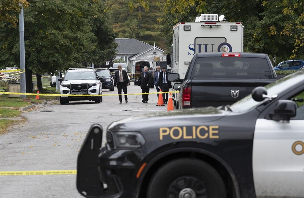 Police and SIU investigators gather at the scene where two police officers were killed in Innisfil, Ont., on Wednesday, Oct. 12, 2022. 