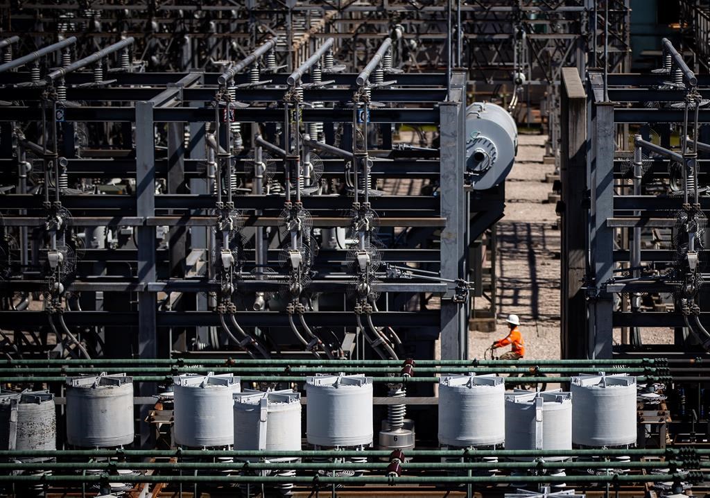 A worker rides a bike at a BC Hydro substation in Vancouver, on Friday, April 16, 2021.