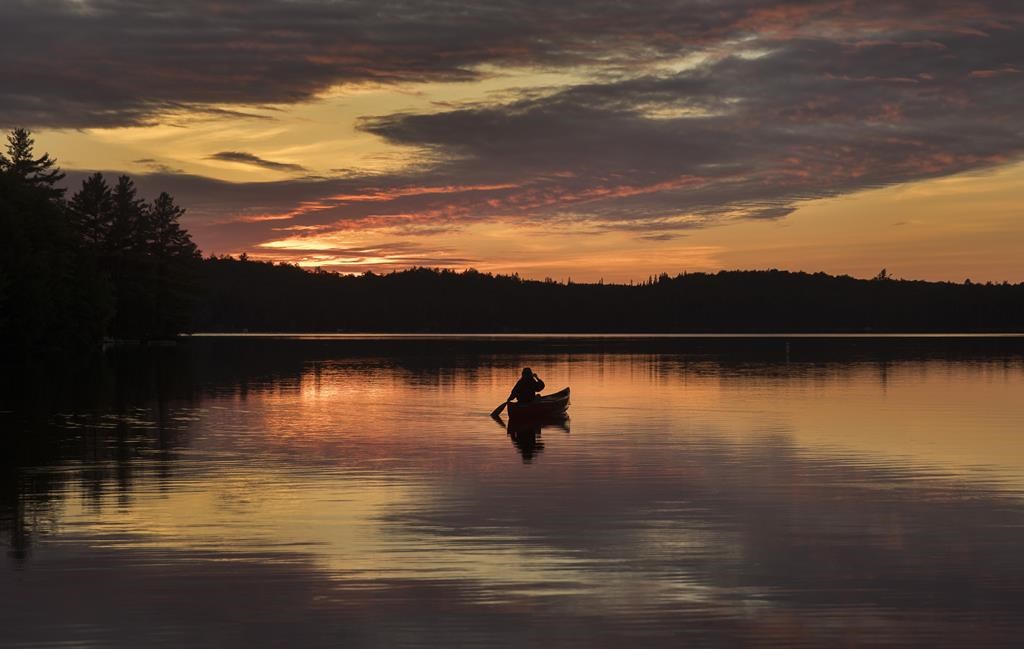 Olivia Gerelus goes for a sunset paddle in Algonquin Park Friday June 11, 2021. Ontario Parks says it is cutting the maximum length of stay at several provincial campgrounds next summer amid a surge in demand. 