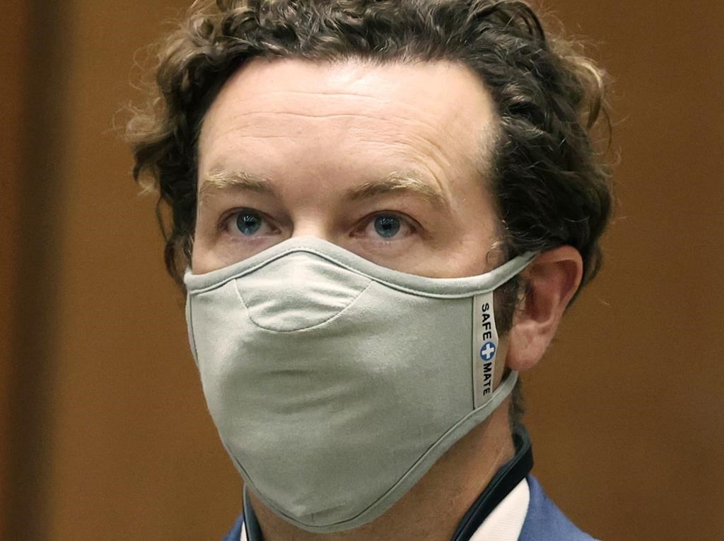 Danny Masterson wearing a gray cloth face mask.