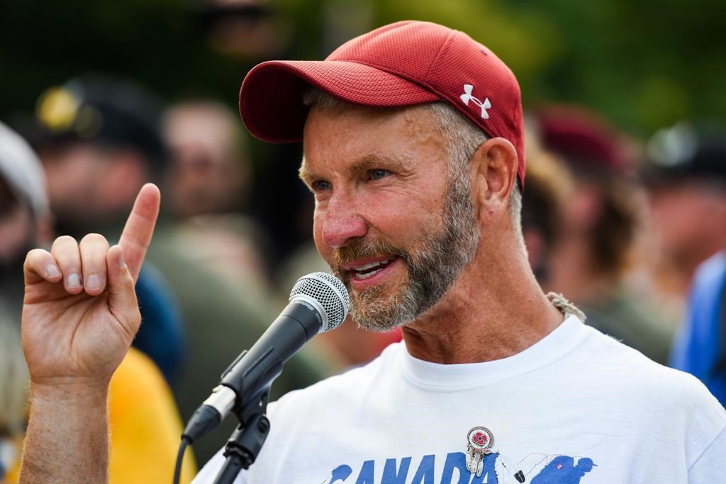 Army reservist James Topp speaks to the crowd during a protest against COVID-19 health measures at the National War Memorial in Ottawa, Ont. on June 30, 2022. The Canadian soldier pleaded guilty to two charges at a court-martial. THE CANADIAN PRESS/Spencer Colby.