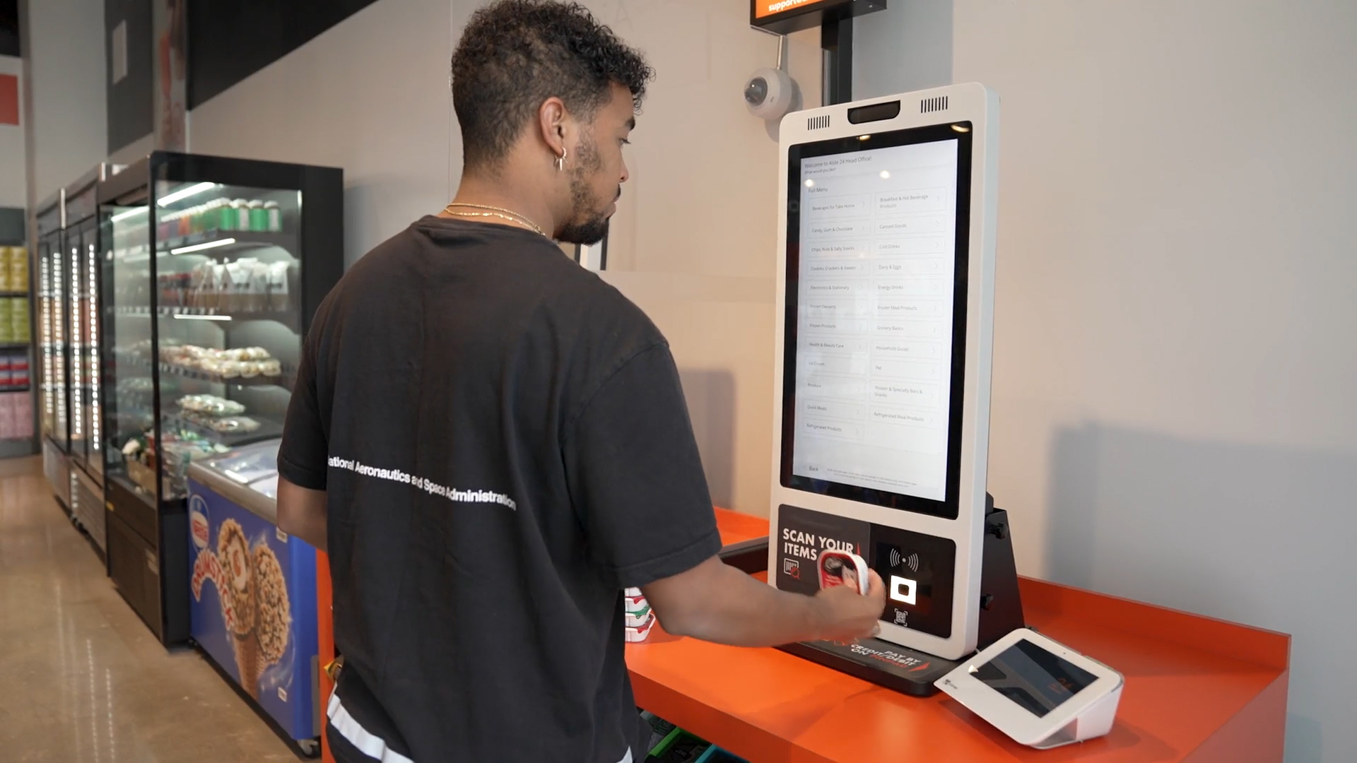 Customer using the self-checkout at Aisle 24