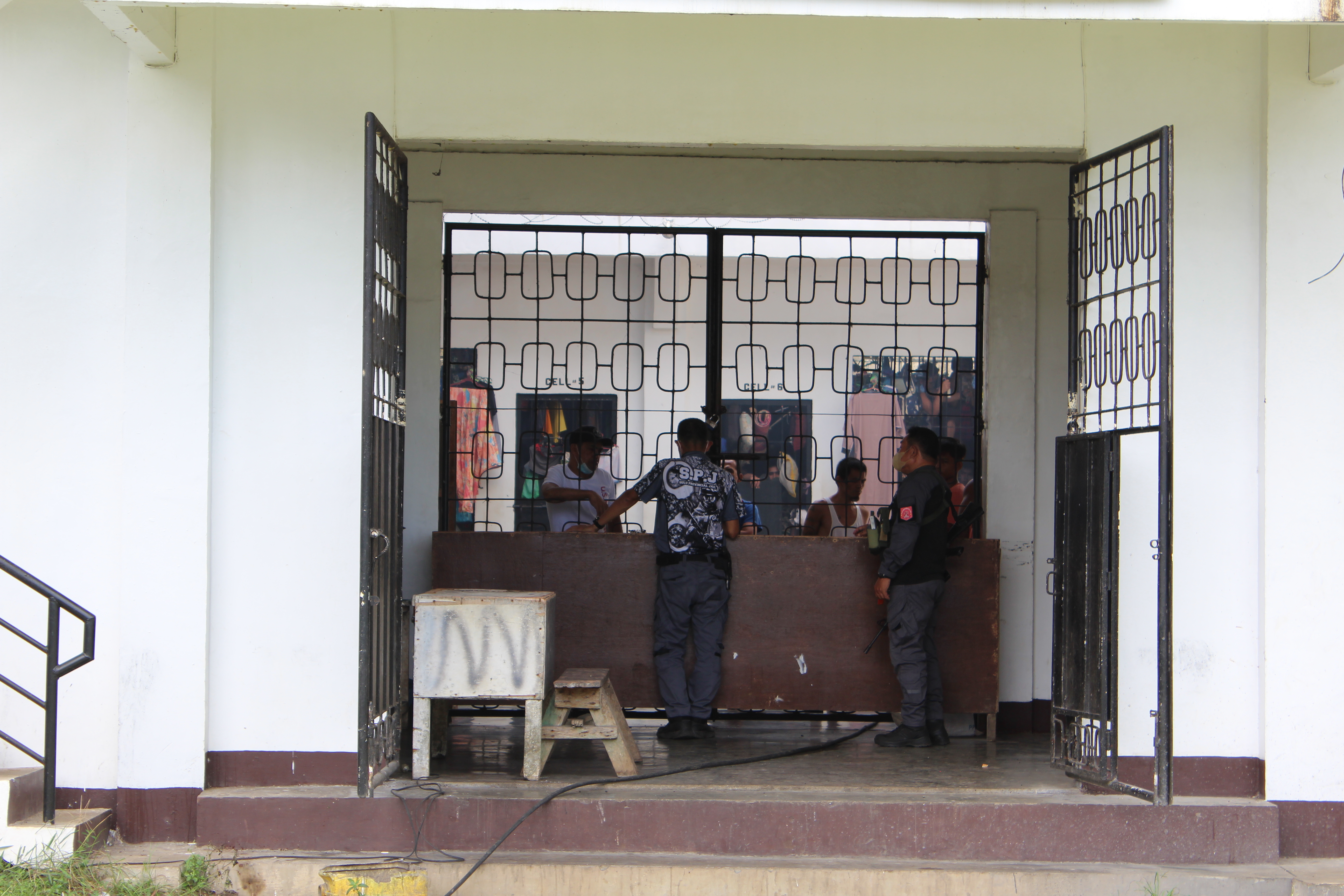 Ben Tattoo, left, speaks to warden at jail in Jolo, southern Philippines.
