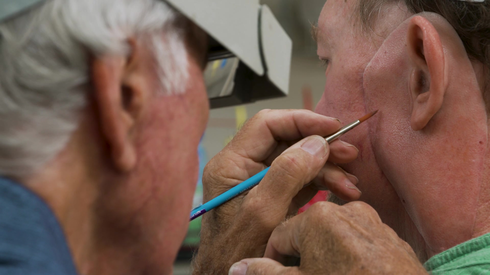 Robert Barron putting the final touches on Steve Butler’s new ear and neck flap.