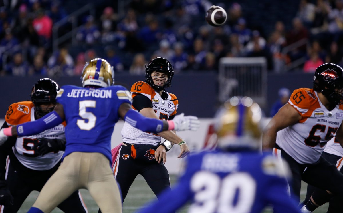 B.C. Lions quarterback Nathan Rourke, middle, throws a pass against the Winnipeg Blue Bombers during first-half CFL action in Winnipeg Friday, October 28, 2022.
