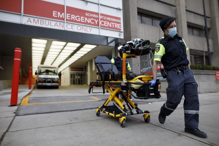 Paramedics wheel a gurney out from the emergency department at Mount Sinai Hospital in Toronto, Wednesday, Jan. 13, 2021.  