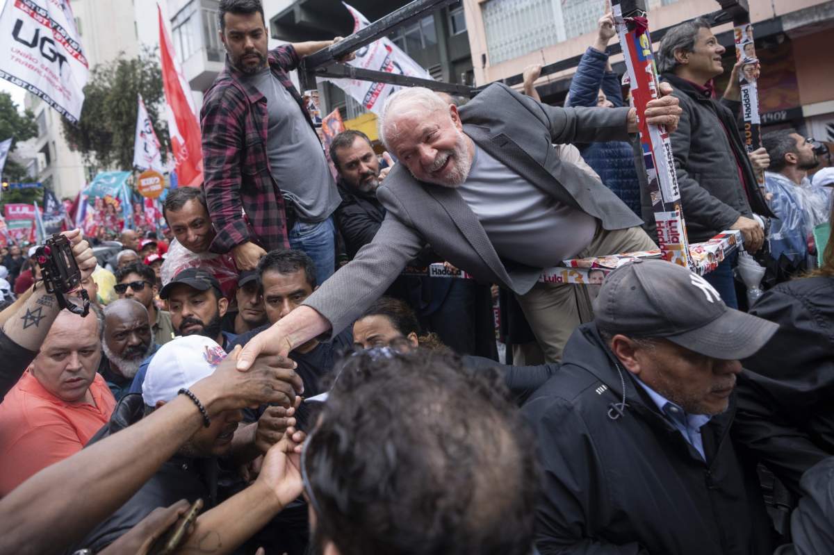 Brazil’s former President Luiz Inacio Lula da Silva, who is running for president, shake hands with a supporter as he campaigns a day ahead of the country’s general election, in Sao Paulo, Brazil, Saturday, Oct. 1, 2022. (AP Photo/Victor R. Caivano)