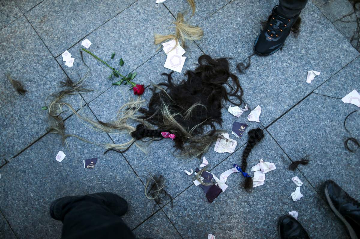 Strands of hair lie on the ground after women cut their hair during a protest against the death of Iranian Mahsa Amini, in Istanbul, Turkey, Sunday, Oct. 2, 2022. As anti-government protests roil cities and towns in Iran for a fourth week, sparked by the death of the 22-year-old woman detained by Iran’s morality police, tens of thousands of Iranians living abroad have marched on the streets of Europe, North America and beyond in support of what many believe to be a watershed moment for their home country.