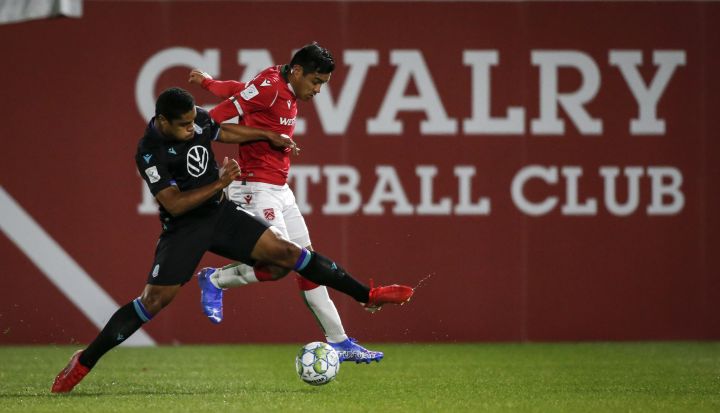 Pacific FC's Terran Campbell, left, and Cavalry FC's Jose Escalante battle for the ball during first half soccer action in the Canadian Championship quarterfinal in Calgary, Alta., Wednesday, Sept. 22, 2021.